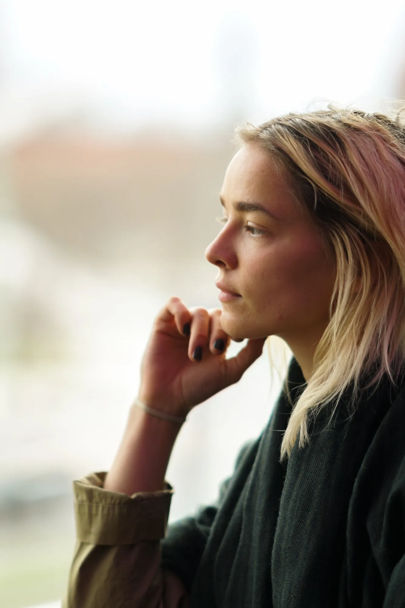 A woman turned away from the camera, deep in thought