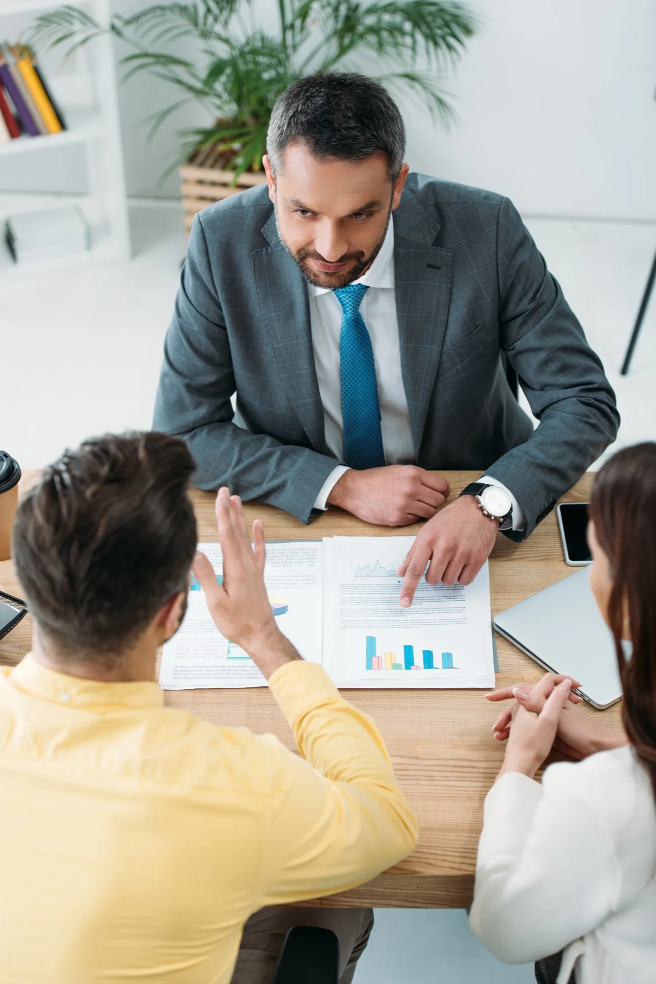 An advisor working through figures with clients at a table